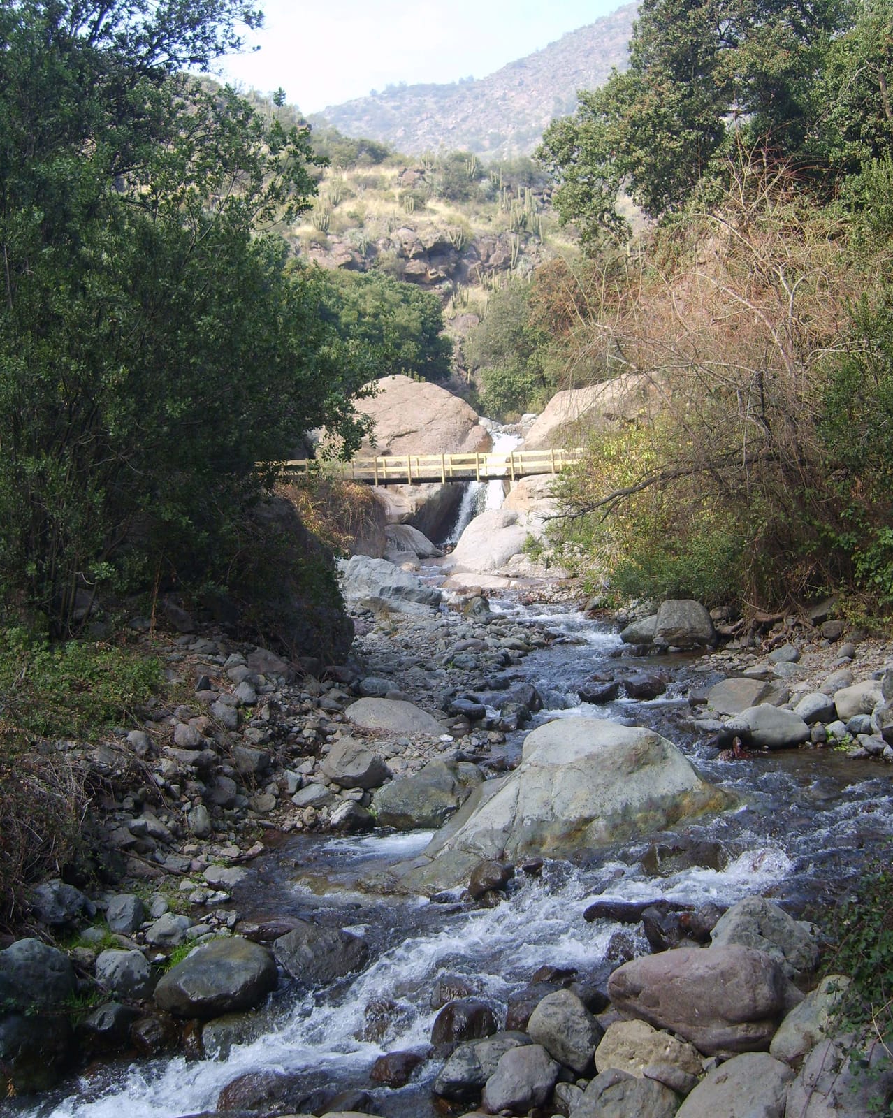 Small waterfall and pools between rocks and forest in Aguas de Ramón
